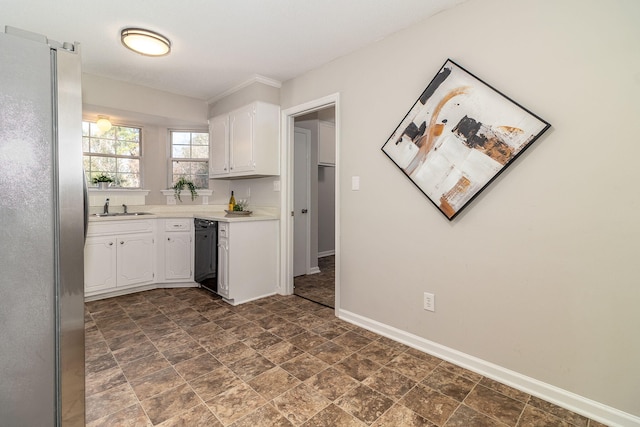 kitchen featuring dishwasher, sink, white cabinets, and stainless steel refrigerator