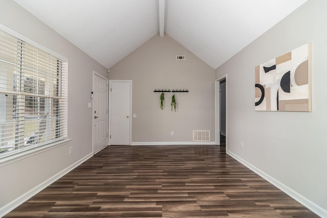 unfurnished room featuring dark hardwood / wood-style floors and vaulted ceiling with beams