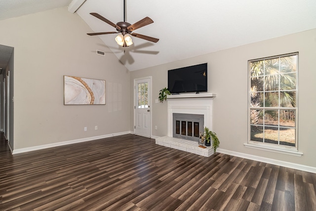 unfurnished living room featuring dark wood-type flooring, ceiling fan, high vaulted ceiling, a fireplace, and beamed ceiling