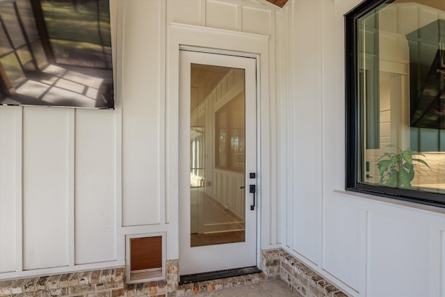 view of exterior entry featuring board and batten siding