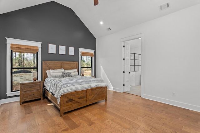 bedroom with multiple windows, wood finished floors, and visible vents