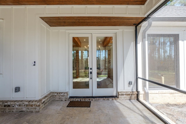 doorway to property featuring french doors and board and batten siding