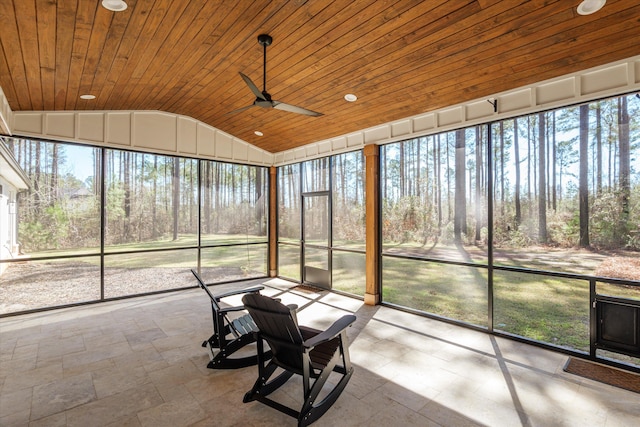 unfurnished sunroom with lofted ceiling, wood ceiling, a wealth of natural light, and ceiling fan