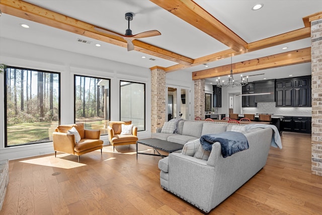 living room featuring beamed ceiling, visible vents, ceiling fan with notable chandelier, recessed lighting, and light wood-style floors