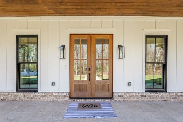 doorway to property with french doors and board and batten siding