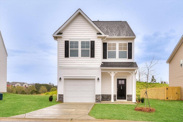 view of front of home featuring a garage and a front lawn