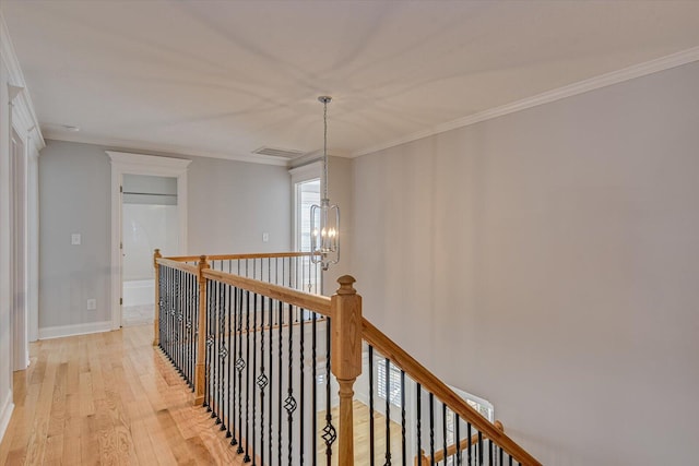 824 Brasstown Ct, Evans, GA 30809 - hallway featuring an upstairs landing, crown molding, light wood-style flooring, and a chandelier