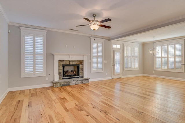 824 Brasstown Ct, Evans, GA 30809 - unfurnished living room featuring wood finished floors, crown molding, ceiling fan, healthy amount of natural light, and a stone fireplace