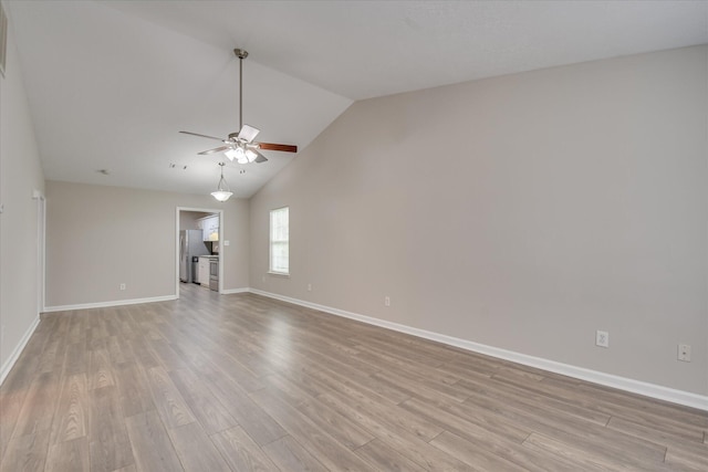 unfurnished living room featuring baseboards, a ceiling fan, light wood-type flooring, and high vaulted ceiling
