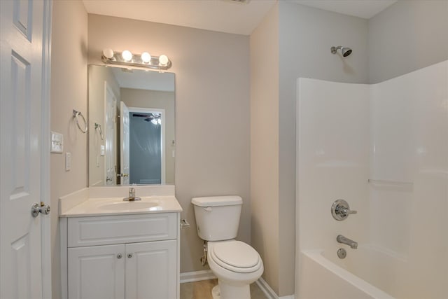 bathroom with vanity, bathing tub / shower combination, toilet, baseboards, and tile patterned floors