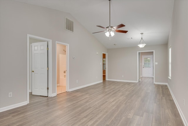 unfurnished living room with ceiling fan, visible vents, high vaulted ceiling, baseboards, and light wood finished floors