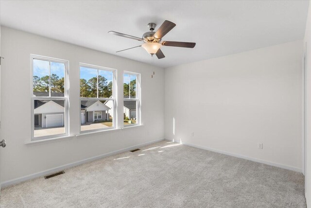 unfurnished room with ceiling fan and light colored carpet