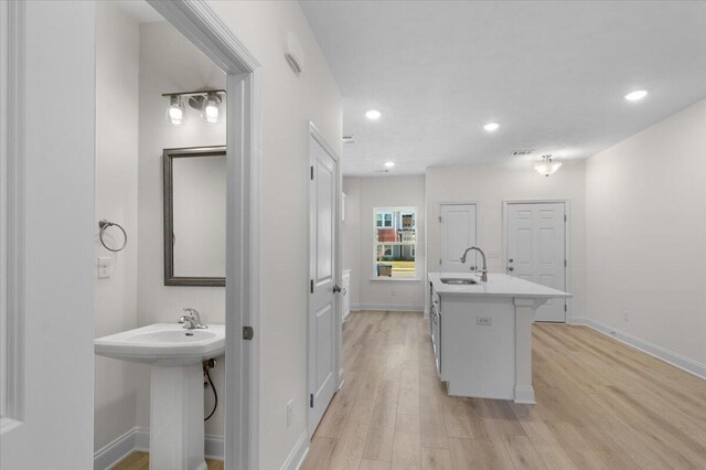 kitchen featuring light wood-type flooring and sink