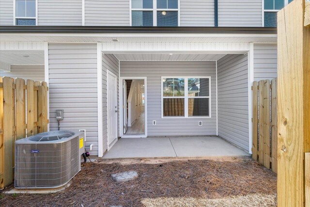 doorway to property with cooling unit and a patio