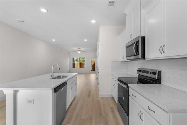 kitchen featuring tasteful backsplash, stainless steel appliances, ceiling fan, sink, and white cabinets