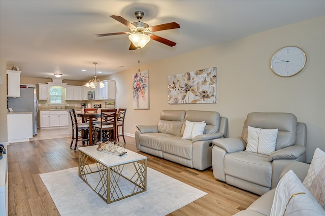 6005 Village W Ln, Graniteville, SC 29829 - living room featuring a ceiling fan, light wood finished floors, and a chandelier