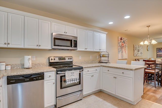 6005 Village W Ln, Graniteville, SC 29829 - kitchen with stainless steel appliances, a chandelier, white cabinetry, and recessed lighting