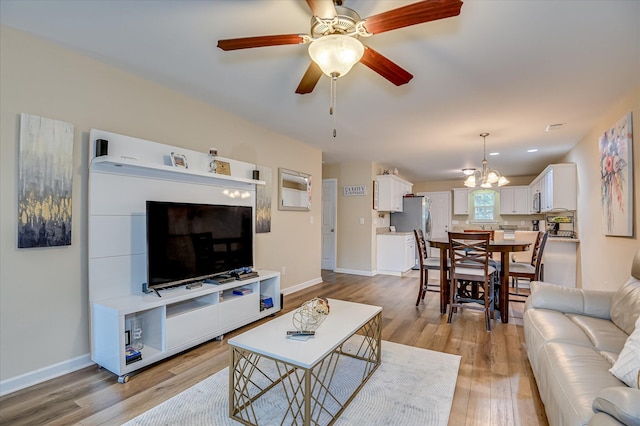 6005 Village W Ln, Graniteville, SC 29829 - living room featuring light wood finished floors, a ceiling fan, and a chandelier