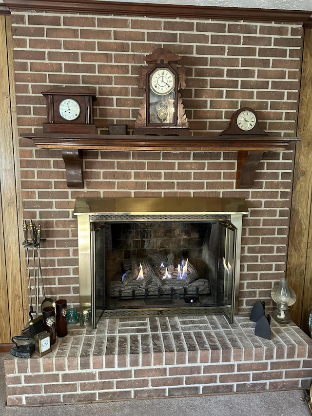 room details featuring carpet floors and a brick fireplace