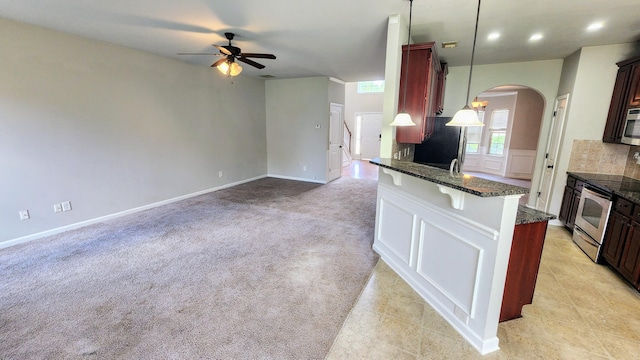 2806 Huntcliffe Dr, Augusta, GA 30909 - kitchen with ceiling fan, arched walkways, stainless steel appliances, dark stone countertops, and backsplash