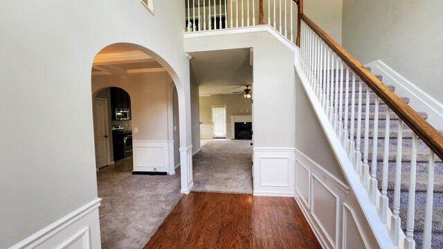 2806 Huntcliffe Dr, Augusta, GA 30909 - staircase with ceiling fan, arched walkways, wood finished floors, a decorative wall, and carpet