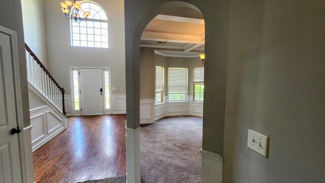 2806 Huntcliffe Dr, Augusta, GA 30909 - entryway featuring a chandelier, arched walkways, a decorative wall, beamed ceiling, and stairway