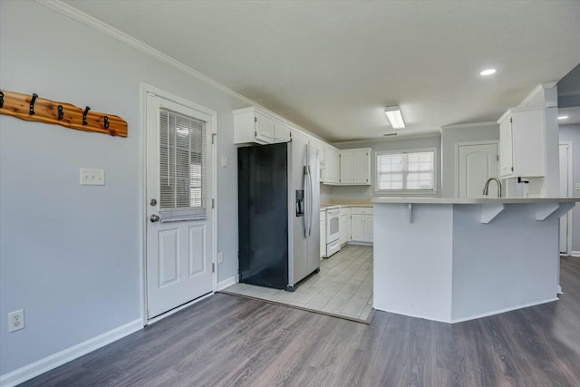 kitchen featuring light wood finished floors, stainless steel fridge with ice dispenser, a peninsula, white electric range, and white cabinetry