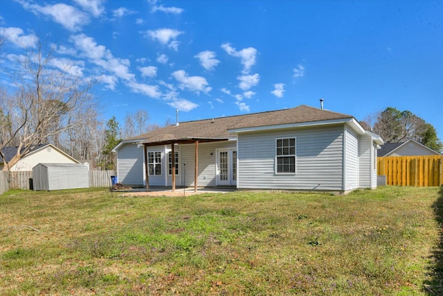 back of property featuring french doors, a patio area, a yard, and fence