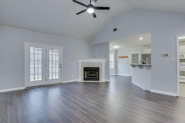 unfurnished living room featuring dark wood-style floors, visible vents, a fireplace, and baseboards