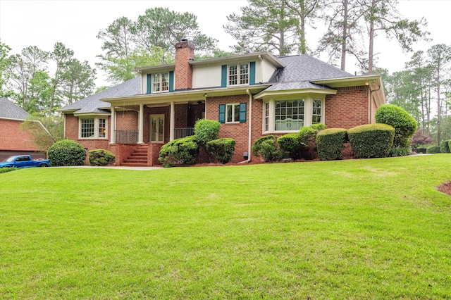 714 Jones Crk, Evans, GA 30809 - view of front facade featuring a front yard, a chimney, and brick siding