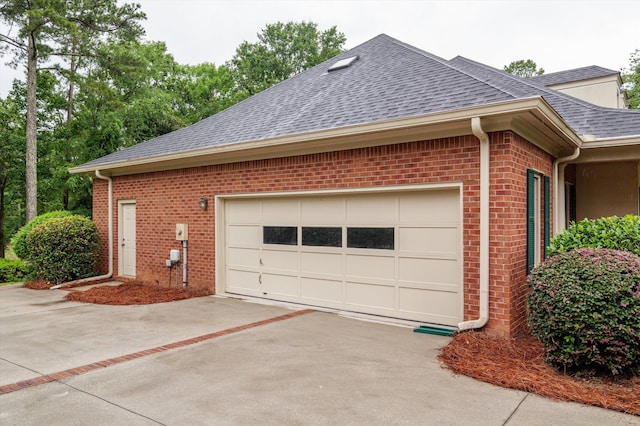 714 Jones Crk, Evans, GA 30809 - view of property exterior featuring a shingled roof, driveway, brick siding, and an attached garage
