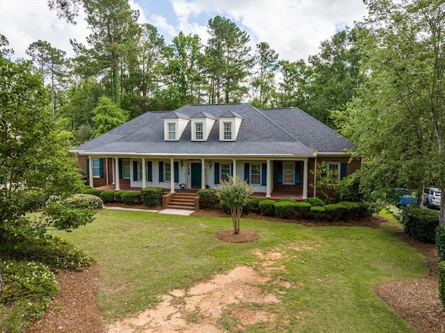 714 Jones Crk, Evans, GA 30809 - new england style home featuring covered porch, a front yard, and a shingled roof