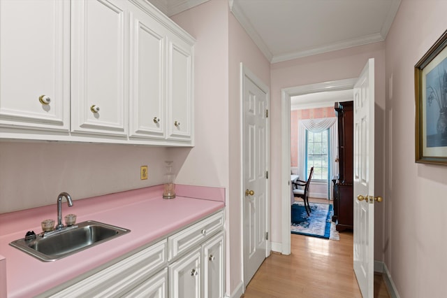 714 Jones Crk, Evans, GA 30809 - kitchen with a sink, crown molding, white cabinets, baseboards, and light countertops