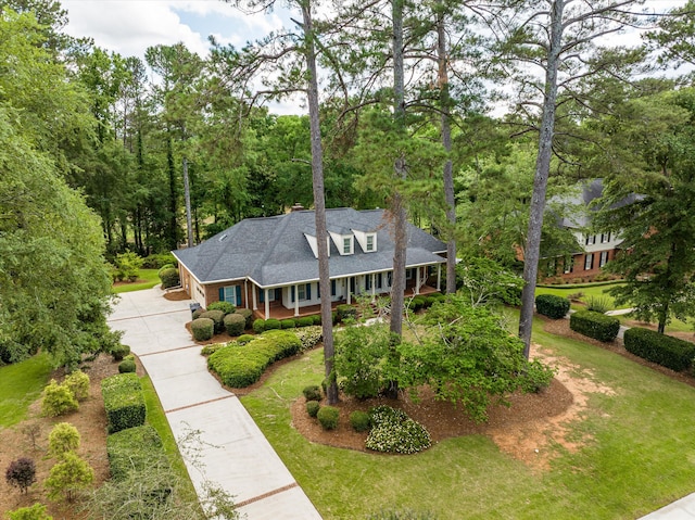 714 Jones Crk, Evans, GA 30809 - view of front facade featuring covered porch, concrete driveway, a front lawn, and a chimney