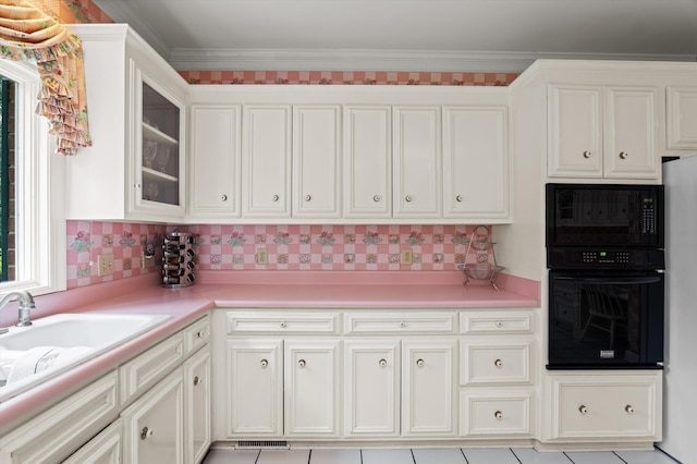 714 Jones Crk, Evans, GA 30809 - kitchen featuring black appliances, light countertops, white cabinetry, decorative backsplash, and crown molding