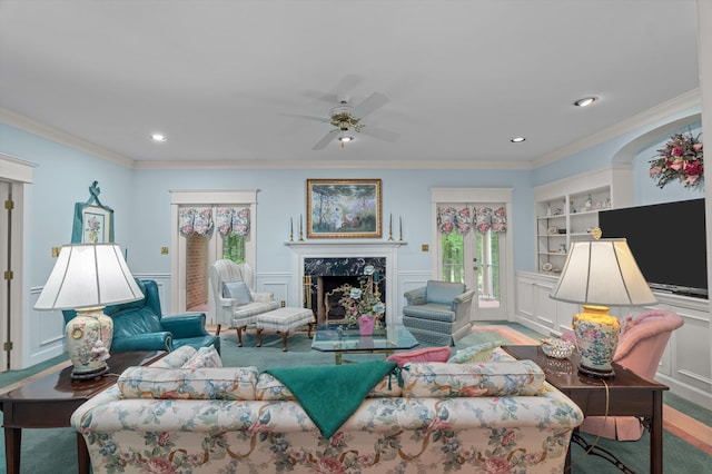 714 Jones Crk, Evans, GA 30809 - living room featuring healthy amount of natural light, a premium fireplace, ceiling fan, ornamental molding, and built in shelves