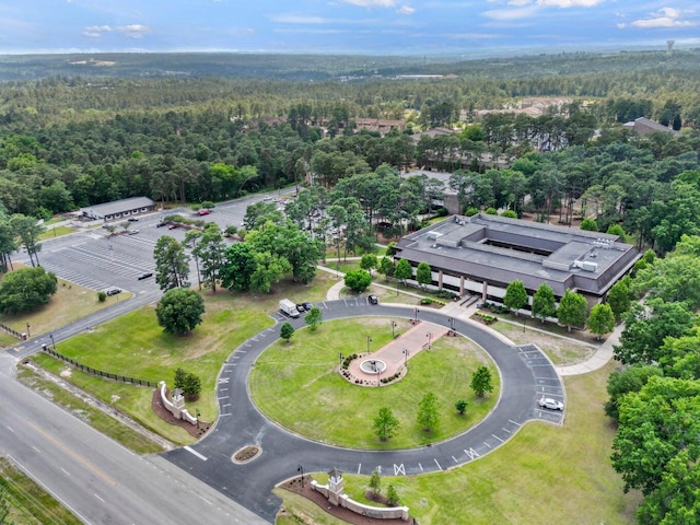 drone / aerial view with a wooded view