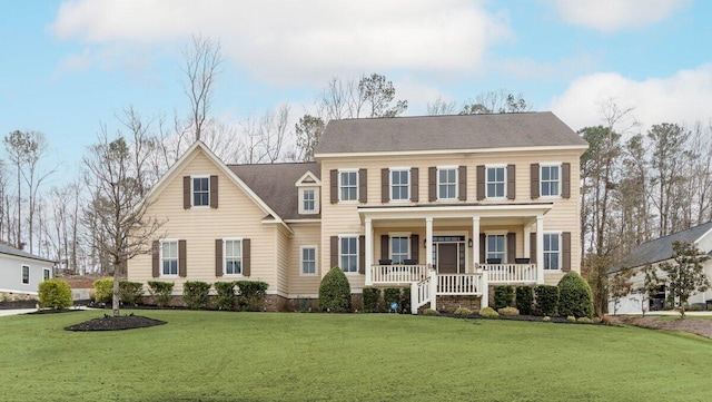 colonial home with a porch and a front lawn