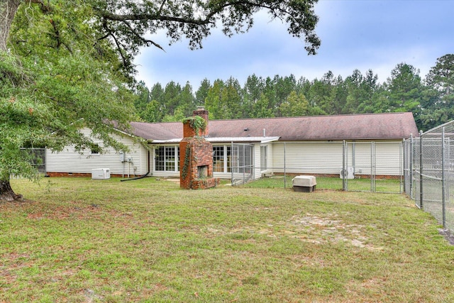 back of property featuring a lawn