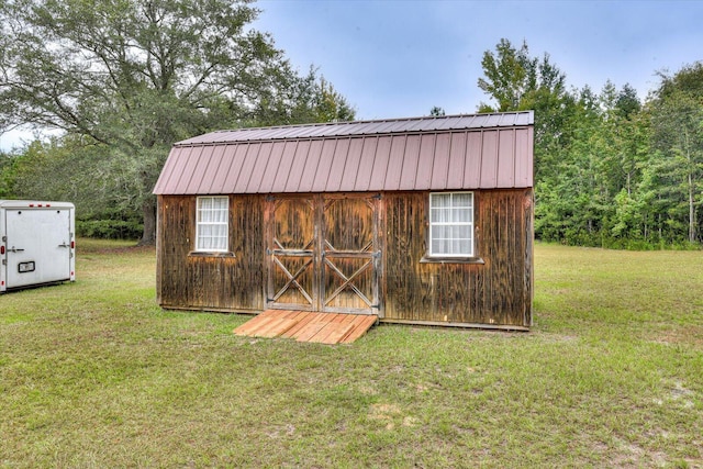 view of outbuilding featuring a yard