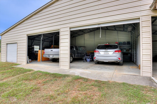 garage featuring a lawn and a carport