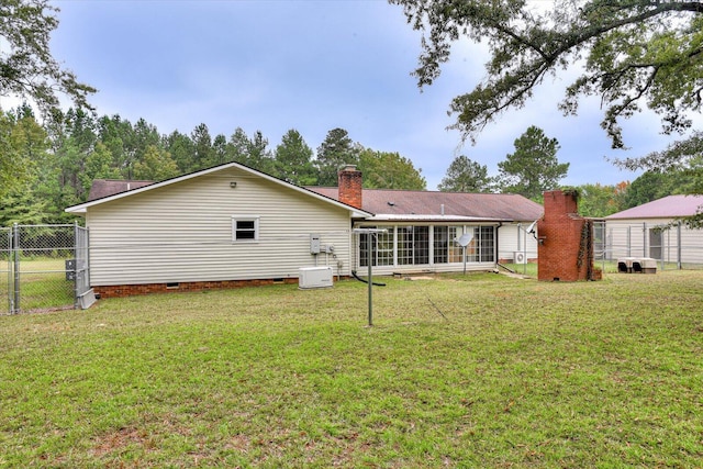 rear view of property featuring a lawn