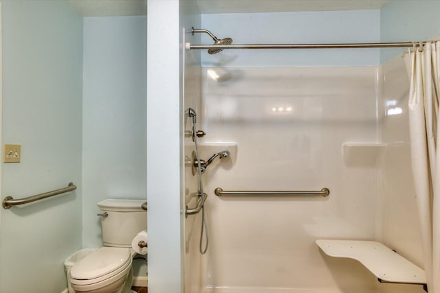 bathroom with toilet and walk in shower