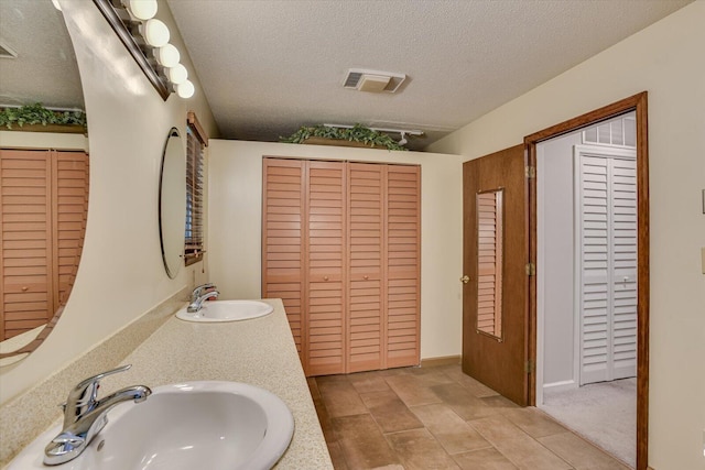 bathroom with vanity and a textured ceiling