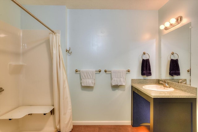 bathroom with tile patterned flooring, vanity, and curtained shower