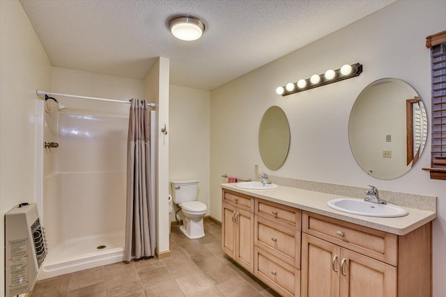 bathroom featuring vanity, a shower with curtain, toilet, a textured ceiling, and heating unit