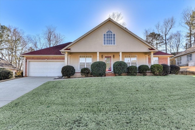 view of front of property featuring a garage, a front yard, and covered porch