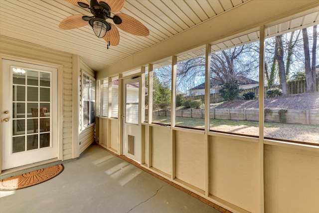 unfurnished sunroom with a wealth of natural light and ceiling fan