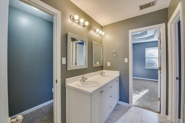 bathroom featuring vanity and a textured ceiling