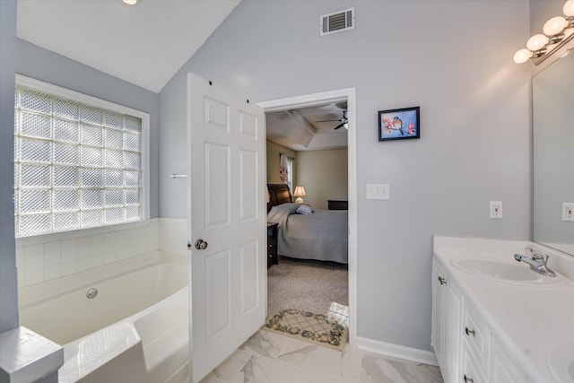 bathroom featuring vanity, a tub to relax in, lofted ceiling, and ceiling fan